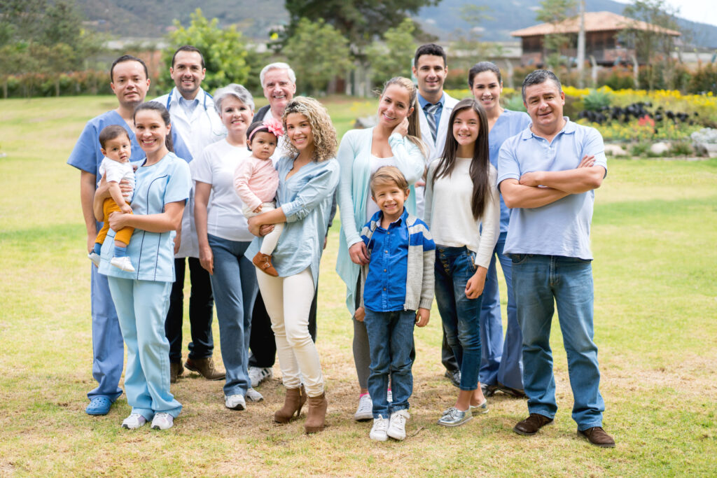 Large group of patients and medical professionals standing outside